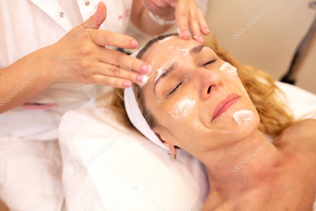 Facial massage with a moisturizer cream