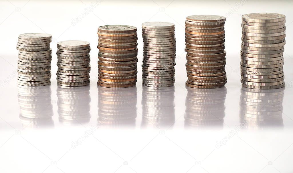 Many coins money are stacked orderly reflection on the ground with white background