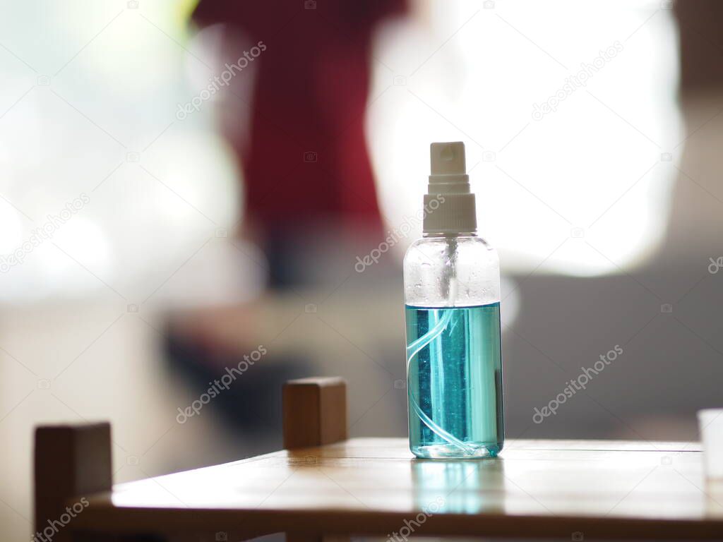 Alcohol 75% in a spray bottle placed on the table, prevent germs protect virus covid 19
