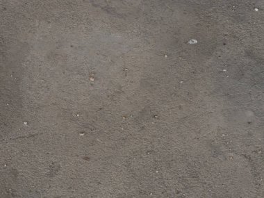 Beton zeminin gri rengi ve kaba yüzey dokusu beton malzeme arka planı var.