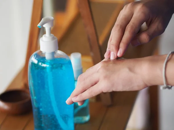 stock image kid is standing with the finger to rub the gel alcoholic 70 percent mixture with gelatin on the back of the hand to prevent germs protect corona virus, covid19, hand Sanitizer