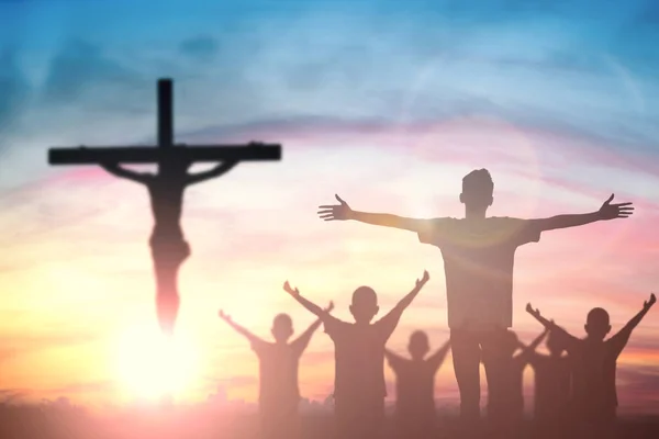 Silhouette of man with raised hands over blur cross concept for — Stock Photo, Image