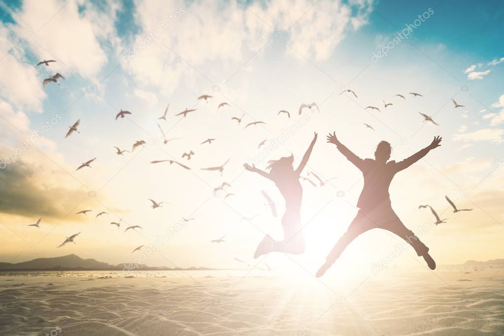 Silhouette of couple jump on beautiful background. 