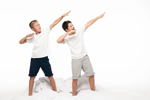 Zwei Brüder Imitieren Bogenschießen Während Sie Isoliert Auf Weißem Bett — Stockfoto