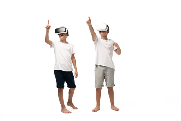 Two Brothers Pointing Fingers While Using Headsets White Background — Stock Photo, Image