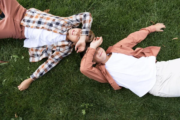 Top View Two Smiling Brothers Covering Eyes Hands While Lying — Stock Photo, Image