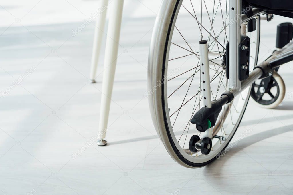 Close up view of wheelchair by table legs