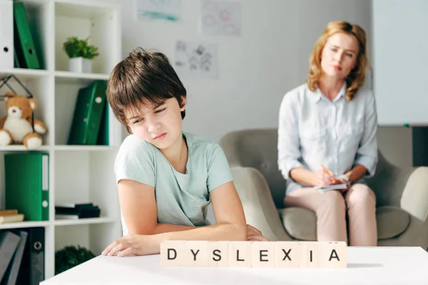 Selective Focus Sad Kid Dyslexia Sitting Table Wooden Cubes Lettering — Stock Photo, Image