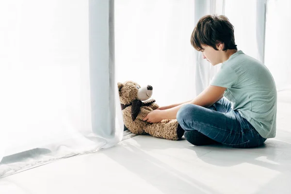 Kind Mit Legasthenie Sitzt Auf Dem Boden Und Schaut Teddybär — Stockfoto