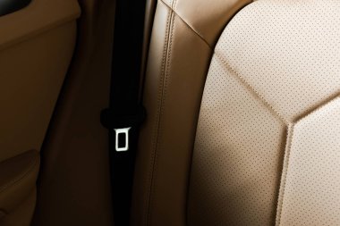KYIV, UKRAINE - OCTOBER 7, 2019: sunshine on leather car seat near seat belt in new luxury porshe  clipart