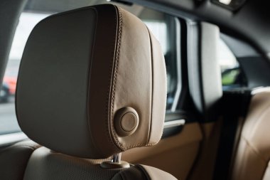 KYIV, UKRAINE - OCTOBER 7, 2019: selective focus of beige headrest in new luxury porshe clipart