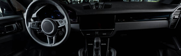 KYIV, UKRAINE - OCTOBER 7, 2019:panoramic shot of steering wheel near gearbox in modern porshe