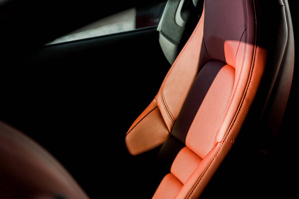 KYIV, UKRAINE - OCTOBER 7, 2019: shadows on leather car seat in new luxury porshe