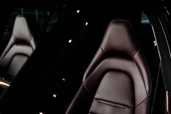 KYIV, UKRAINE - OCTOBER 7, 2019: leather brown car seats in new modern porshe