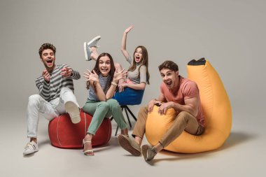 funny laughing friends sitting on different chairs, on grey clipart