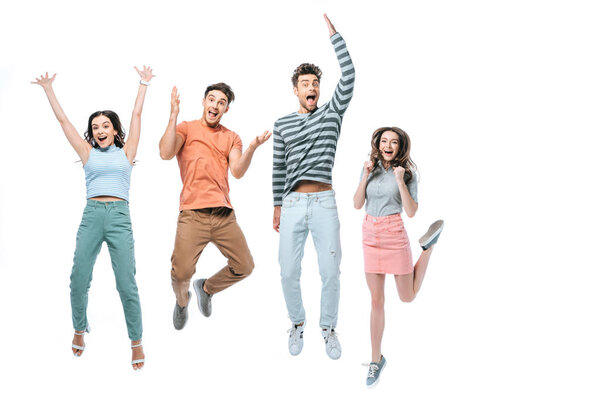 surprised beautiful friends jumping with triumph, isolated on white