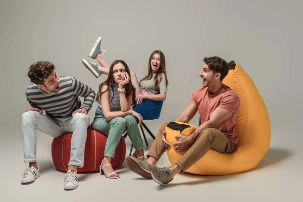 Amigos Emocionais Sentados Cadeiras Diferentes Cinza — Fotografia de Stock