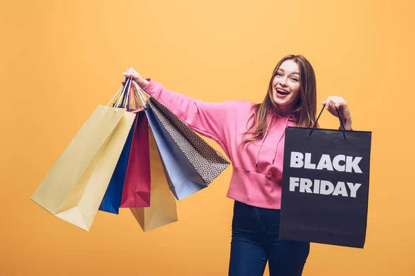 Excited Woman Holding Shopping Bags Black Friday Isolated Yellow — Stock Photo, Image