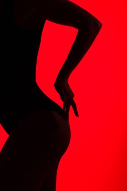 black silhouette of sexy buttocks of passionate woman, isolated on red clipart