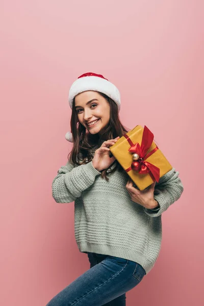 Cheerful Girl Sweater Santa Hat Holding Christmas Gift Isolated Pink — Stock Photo, Image