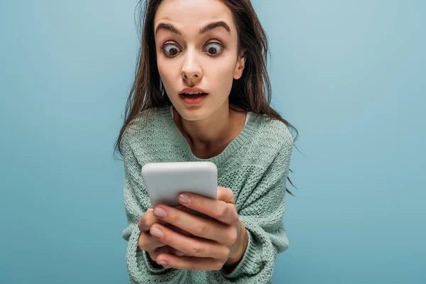 Mulher Chocada Olhando Para Smartphone Isolado Azul — Fotografia de Stock