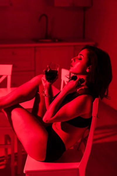 Attractive Sexy Young Woman Glass Wine Sitting Kitchen Red Light — Stock Photo, Image