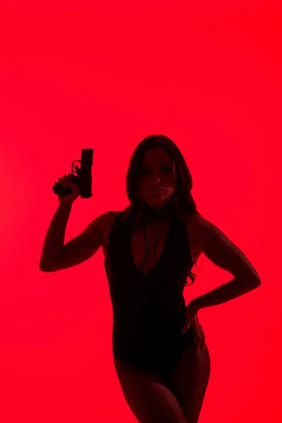 Silhouette Beautiful Woman Bodysuit Holding Gun Isolated Red — Stock Photo, Image