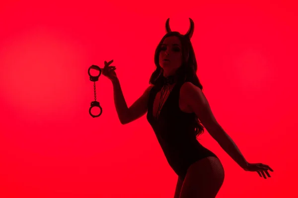 Silhouette Seductive Woman Devil Costume Holding Handcuffs Isolated Red — Stock Photo, Image
