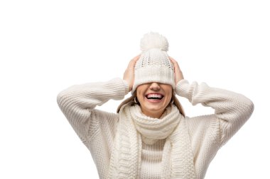 attractive laughing woman warming up in white knitted hat, isolated on white clipart