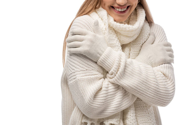cropped view of smiling woman warming up in white knitted clothes, isolated on white