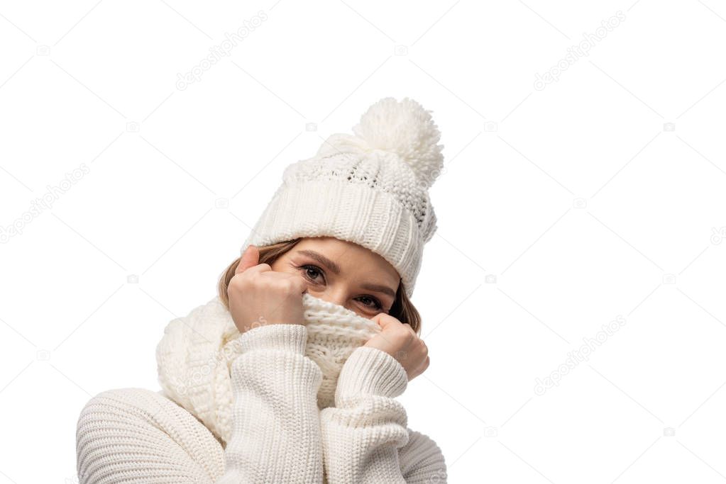 beautiful happy girl warming up in white knitted clothes, isolated on white