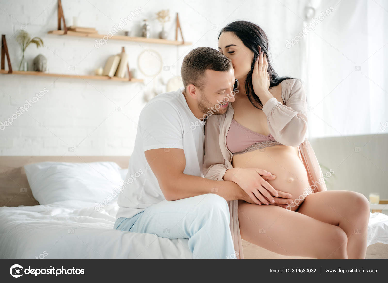 Happy Husband Hugging His Pregnant Wife While She Kissing Him ...