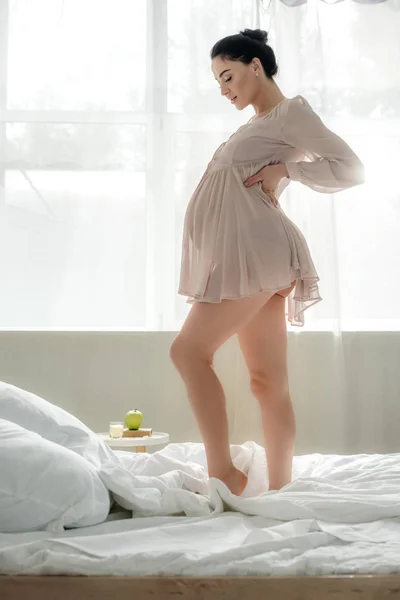 Beautiful Happy Pregnant Woman Nightie Touching Tummy While Standing Bed — Stock Photo, Image