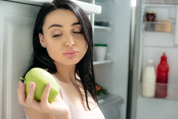 Sad Pregnant Woman Looking Apple While Sitting Opened Fridge Kitchen — Stock Photo, Image