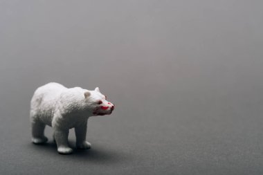 White toy bear with blood on grey background, killing animals concept clipart