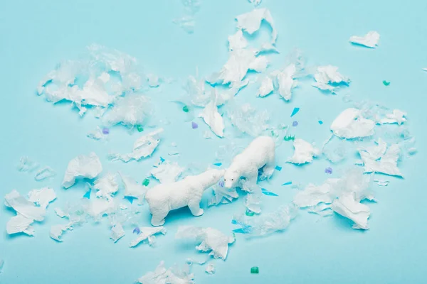 Mavi Arka Planda Polietilen Plastik Parçaları Olan Oyuncak Kutup Ayıları — Stok fotoğraf