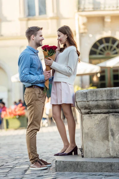 Yakışıklı Adam Sokakta Mutlu Kız Arkadaşına Gül Buketi Sunuyor — Stok fotoğraf