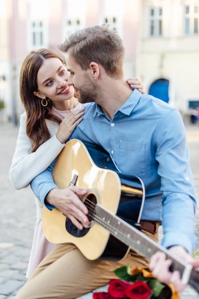 Happy Young Woman Looking Boyfriend Holding Guitar Street — Stock Photo, Image