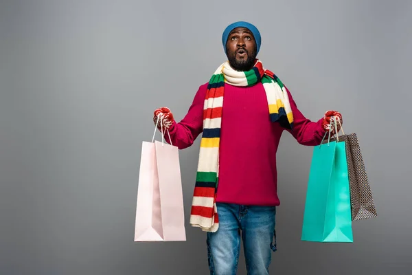 Shocked African American Man Winter Outfit Shopping Bags Grey Background — Stock Photo, Image