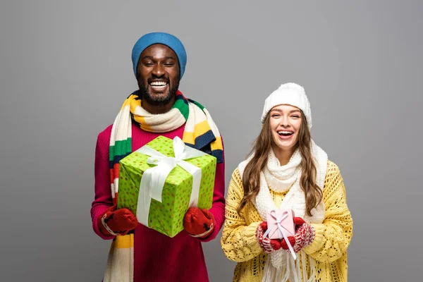 Happy Interracial Couple Winter Outfit Holding Presents Isolated Grey — Stock Photo, Image