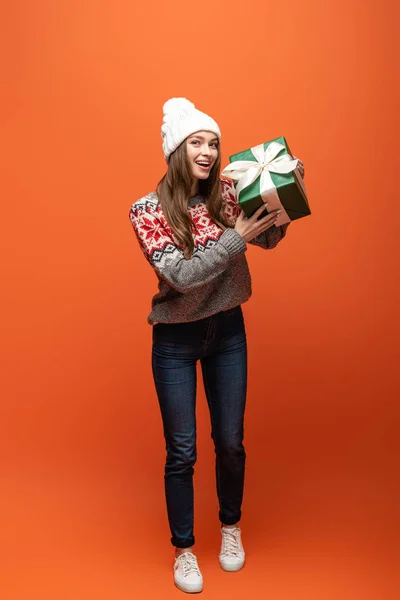 Happy Girl Winter Outfit Holding Present Orange Background — Stock Photo, Image