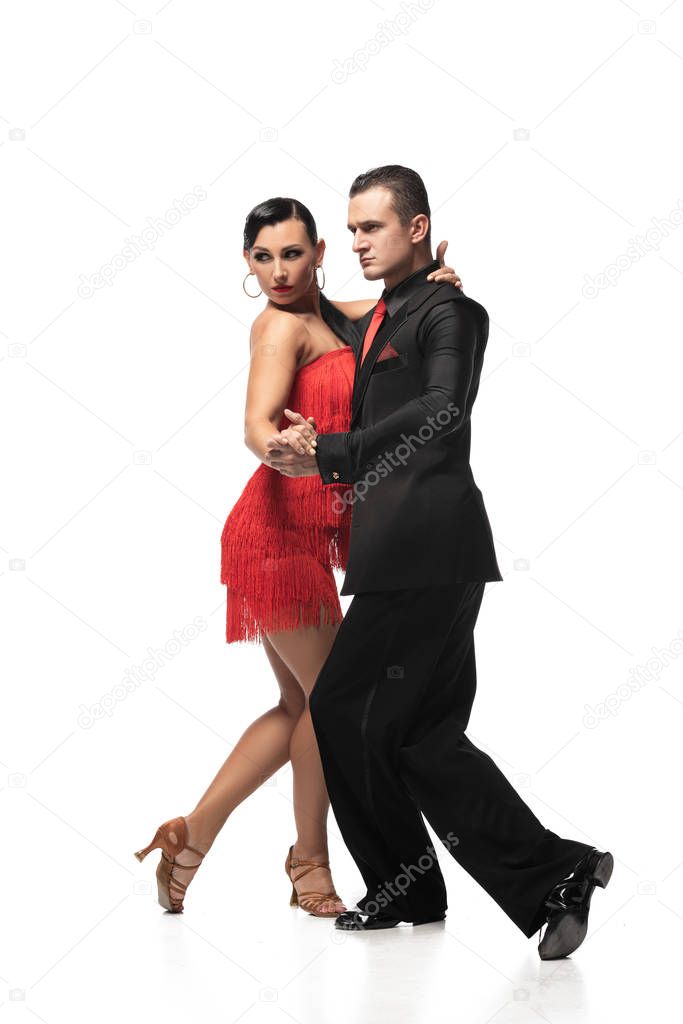 elegant, expressive couple of dancers performing tango on white background