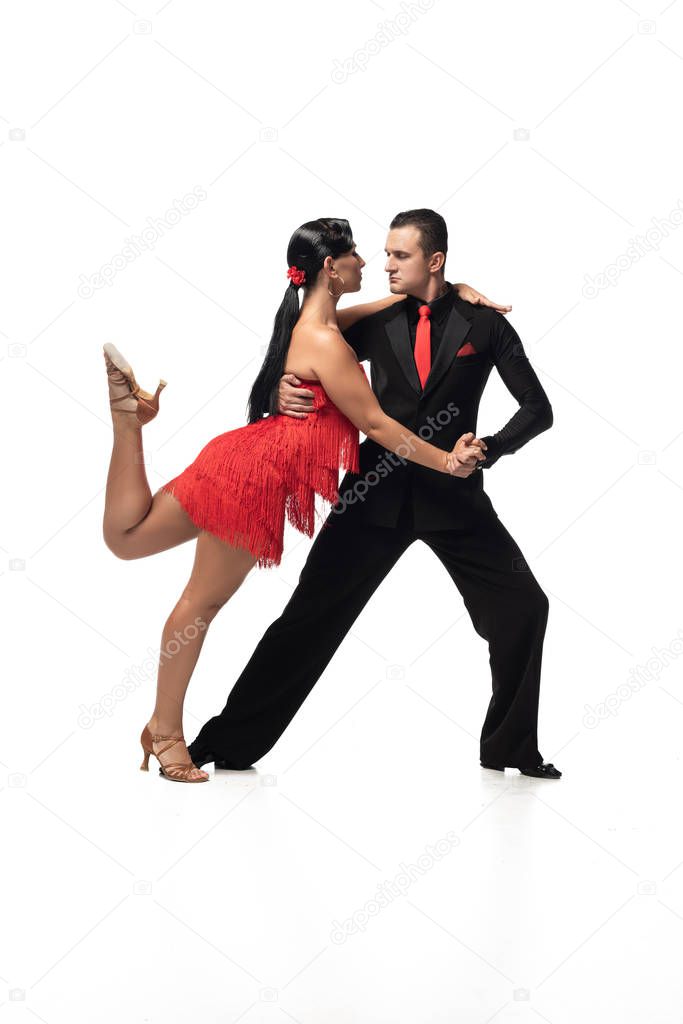 passionate couple of dancers performing tango on white background