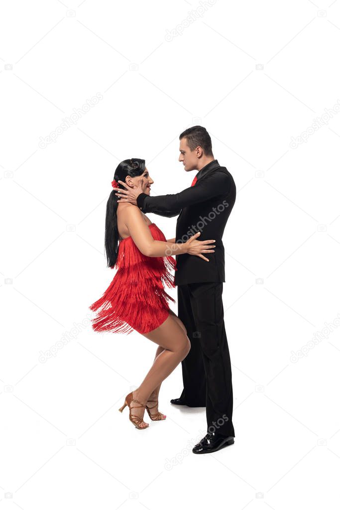 passionate couple of dancers performing tango on white background 