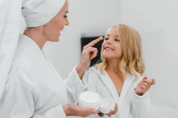 Cheerful Mother Applying Cosmetic Cream Clean Face Daughter — Stock Photo, Image