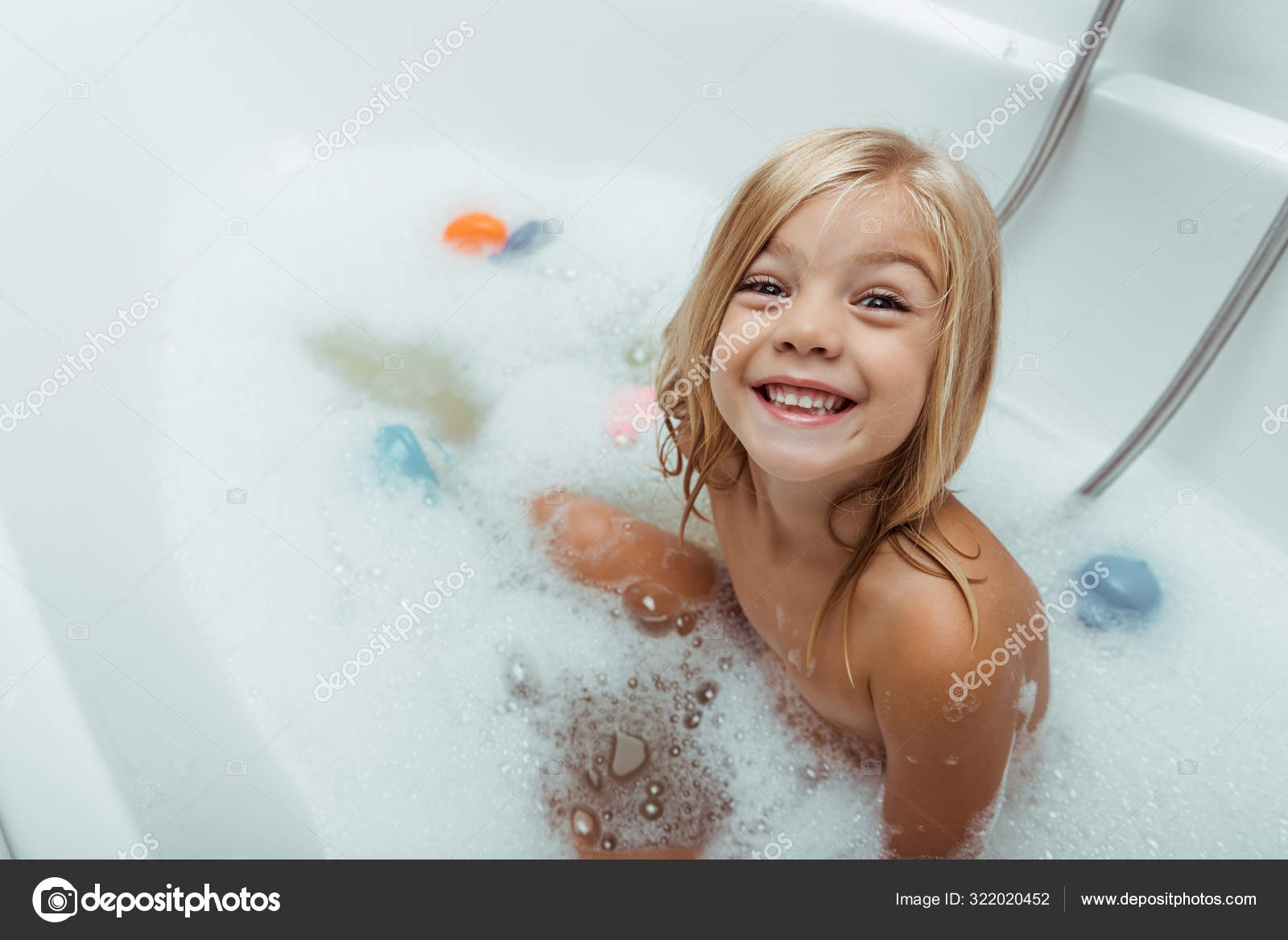 baby naked bath Naked baby sitting in bathtub, looking … – License image ...