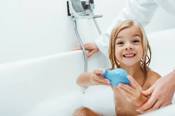 Cheerful Kid Taking Bath Holding Blue Rubber Toy Mother — Stock Photo, Image