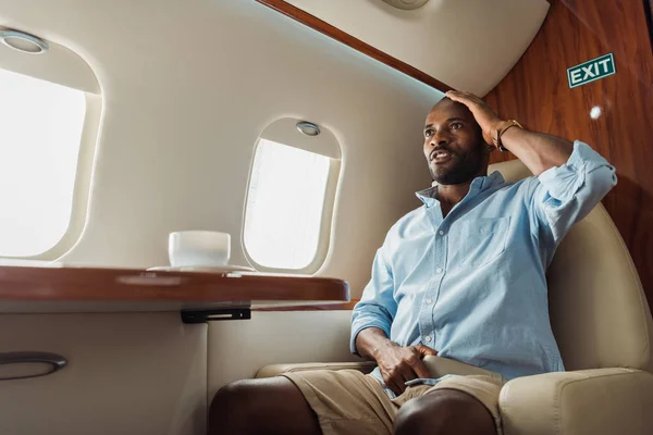 Scared African American Man Touching Head Cup Coffee Plane — Stock Photo, Image