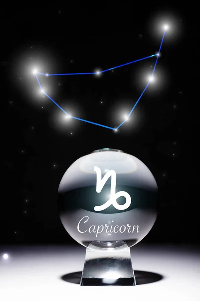 crystal ball with Capricorn zodiac sign isolated on black with constellation