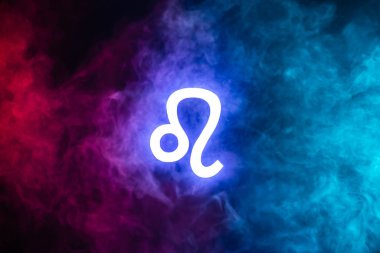 blue illuminated Leo zodiac sign with colorful smoke on background clipart
